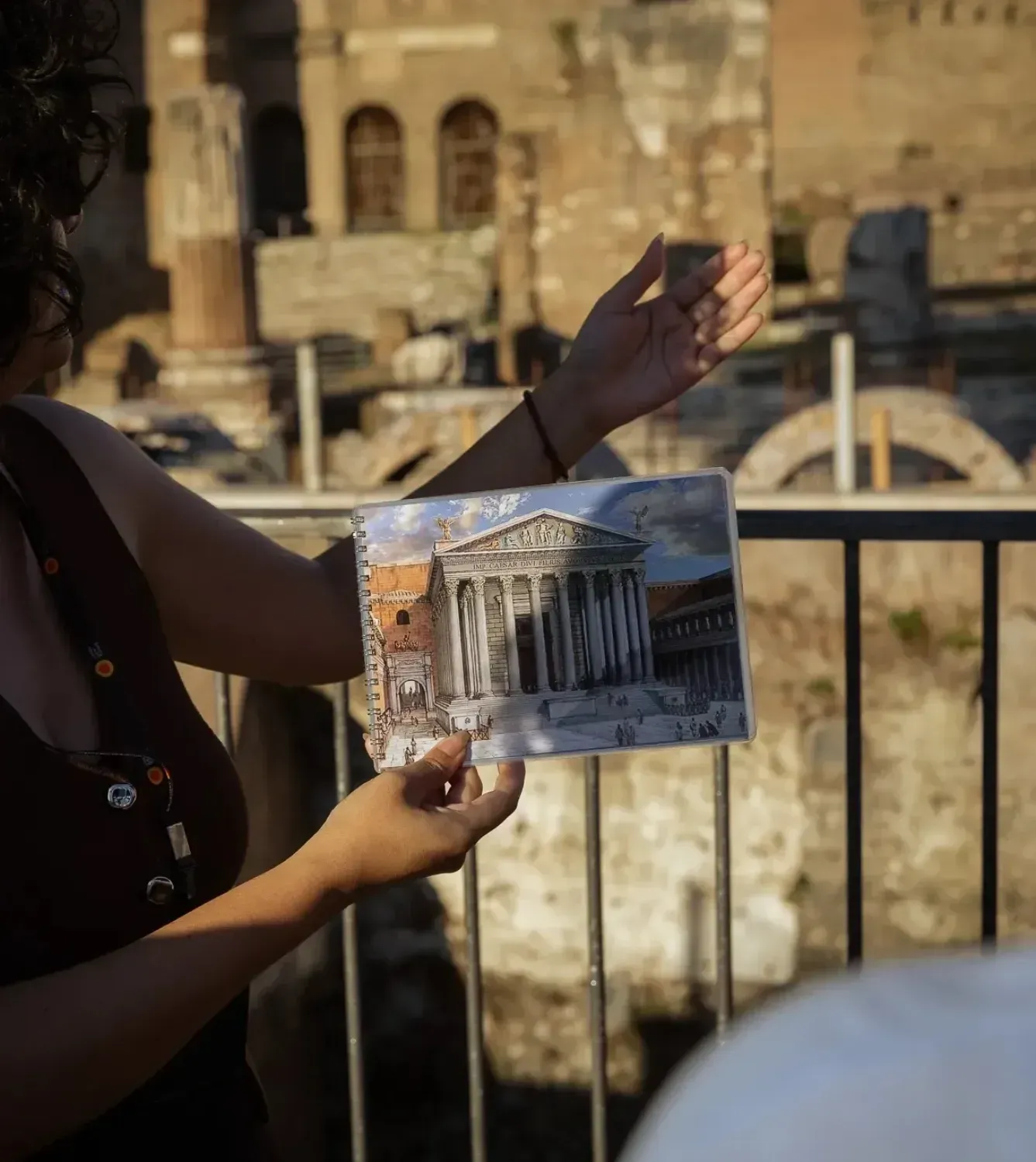Guide holding historical document during Rome Colosseum walking tour