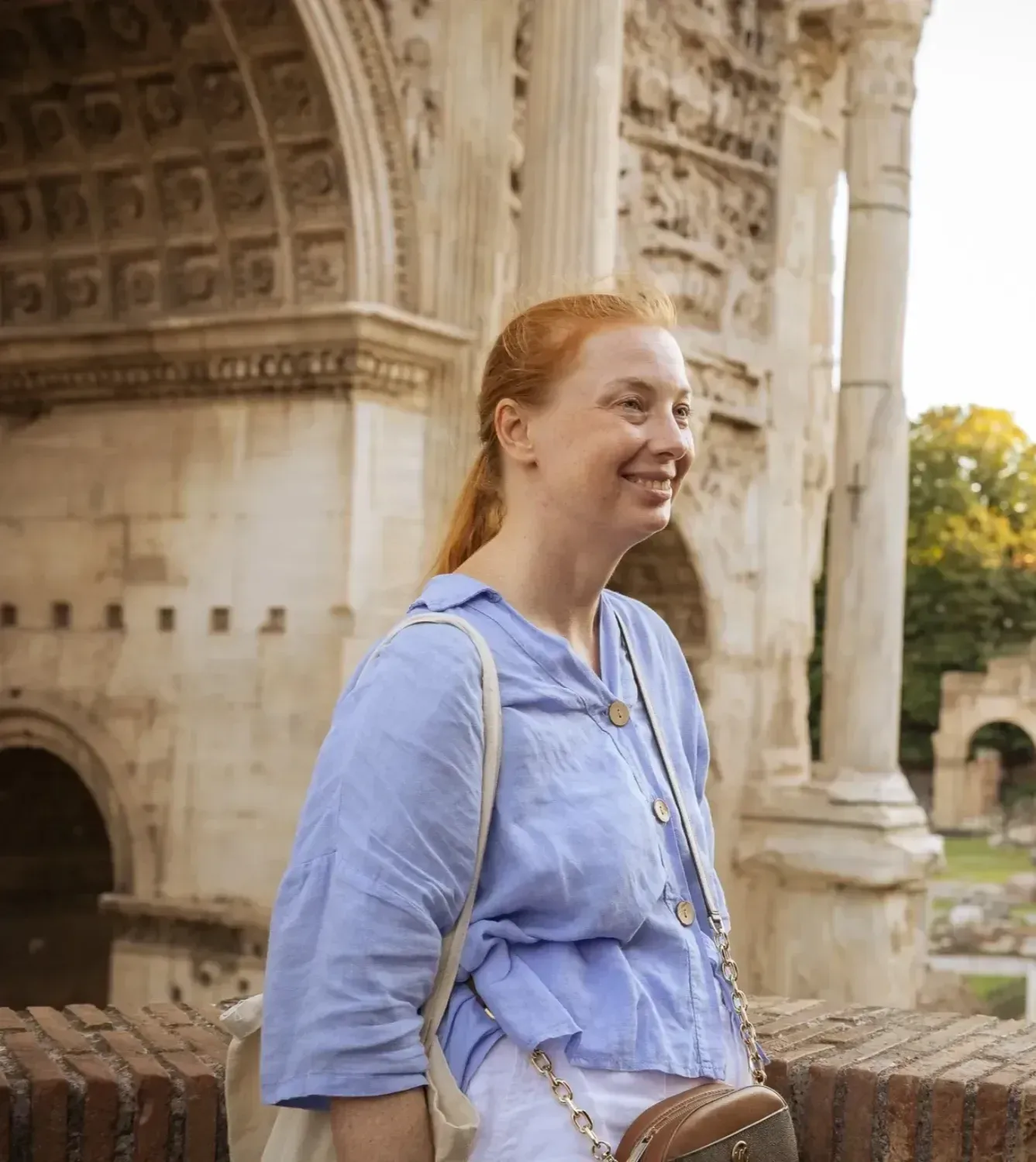 Traveler posing at ancient Roman columns on Colosseum walking tour