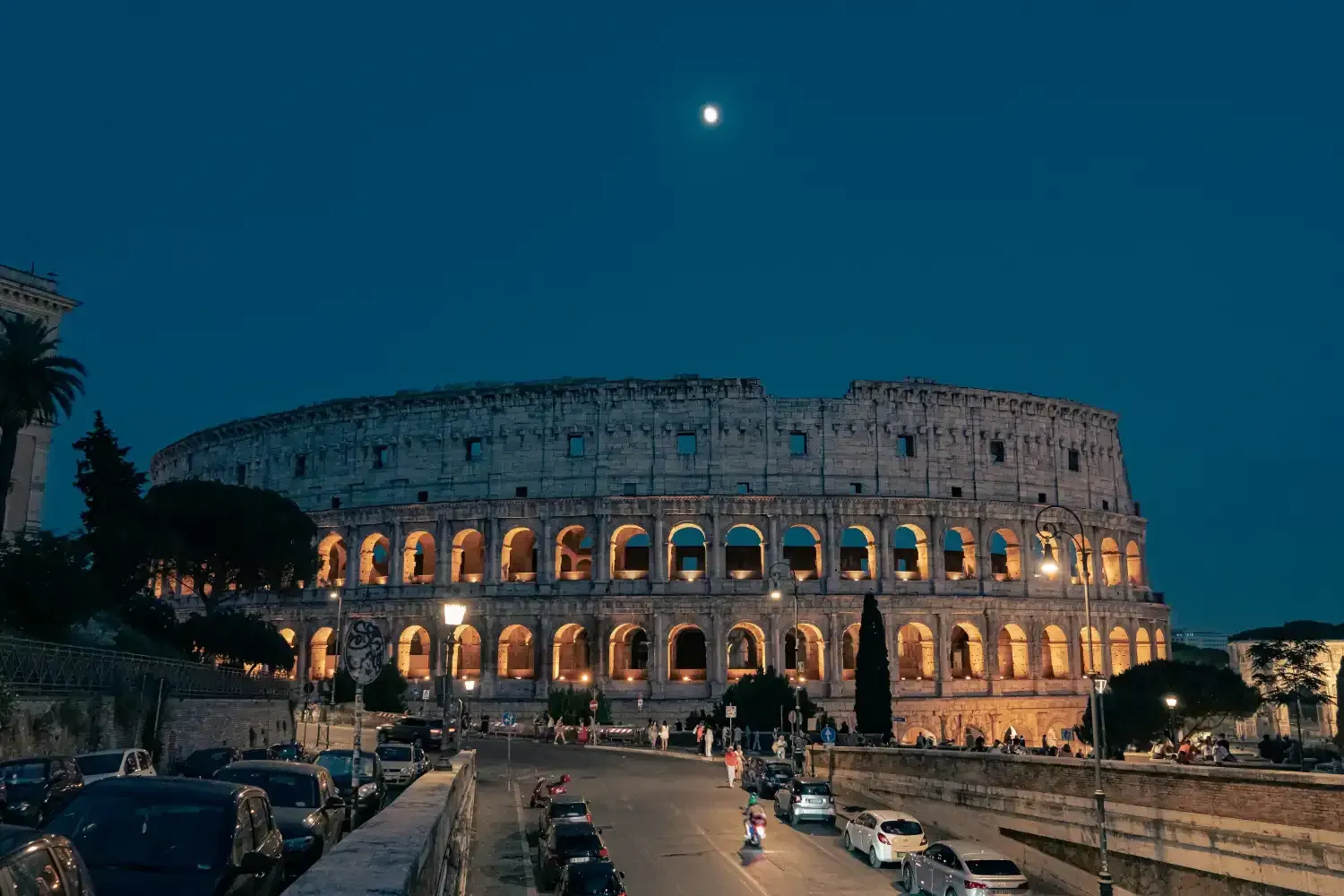 Rome evening cityscape with warm golden lights and historic architecture illuminated at dusk