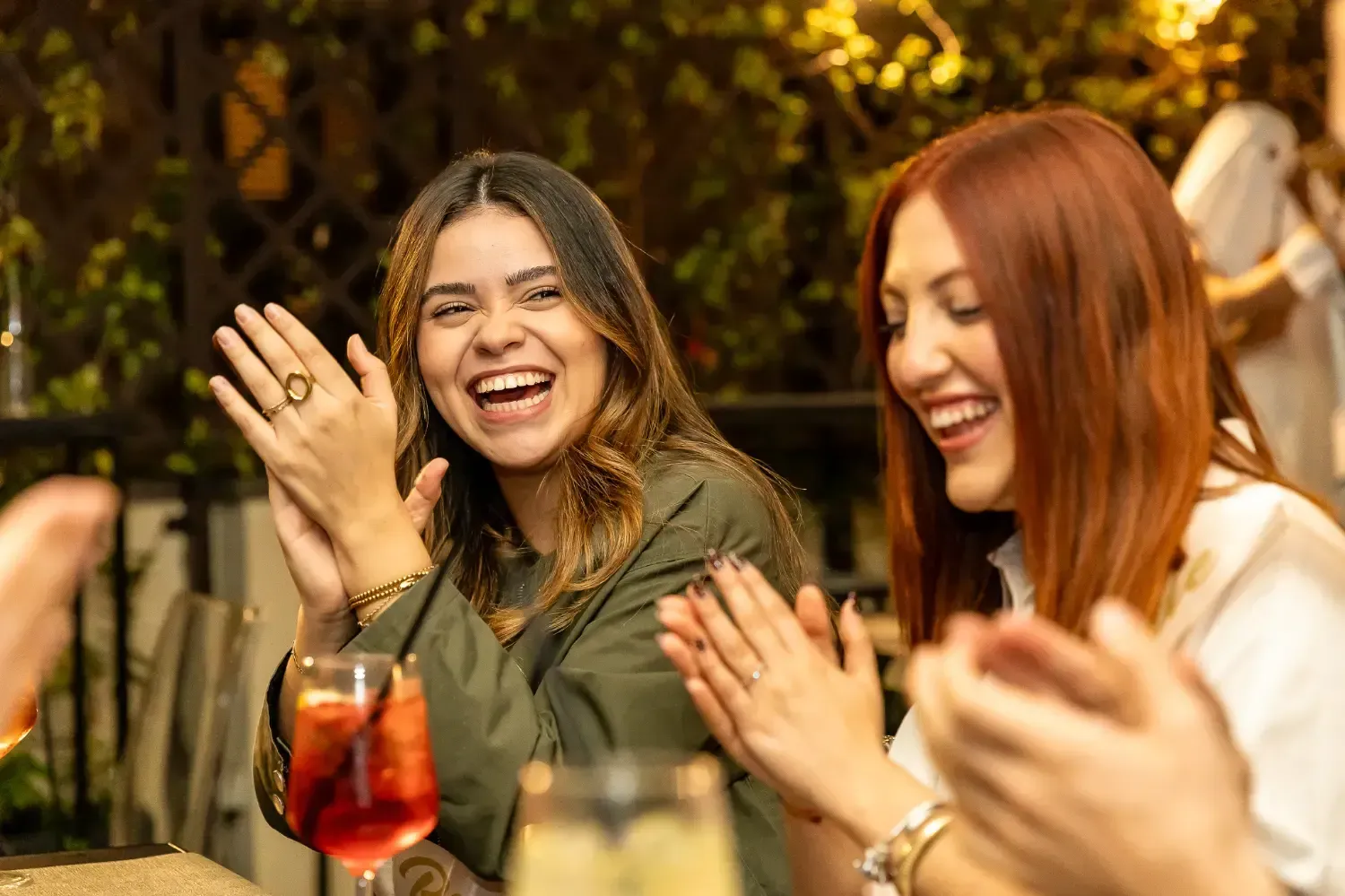 Two women laughing and enjoying food together during Rome Tipsy Tour