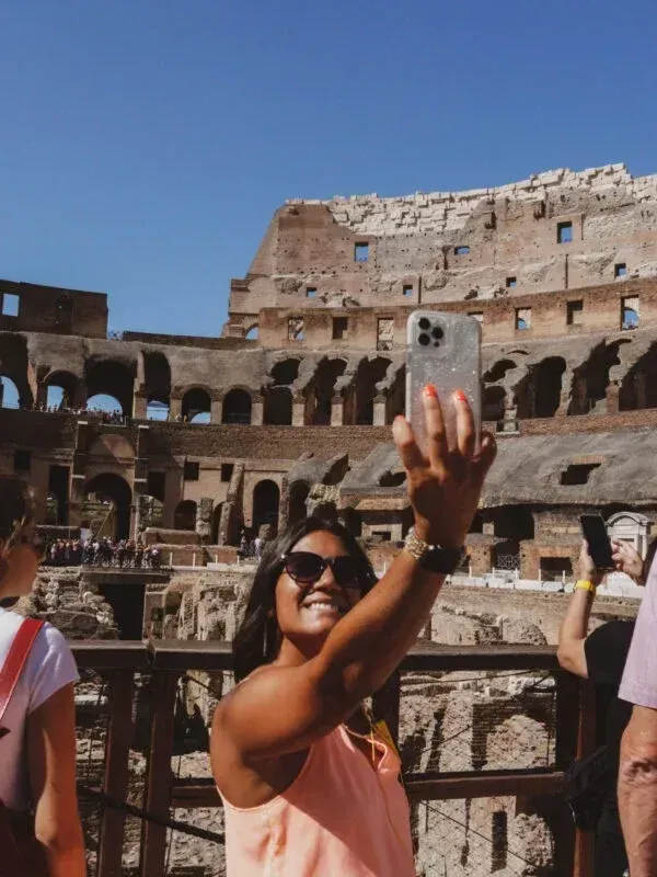 Expert guide leading small group through Colosseum arena floor with ancient ruins visible
