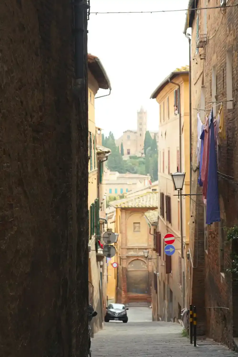 Siena historic buildings with traditional terracotta tile roofs and medieval architecture