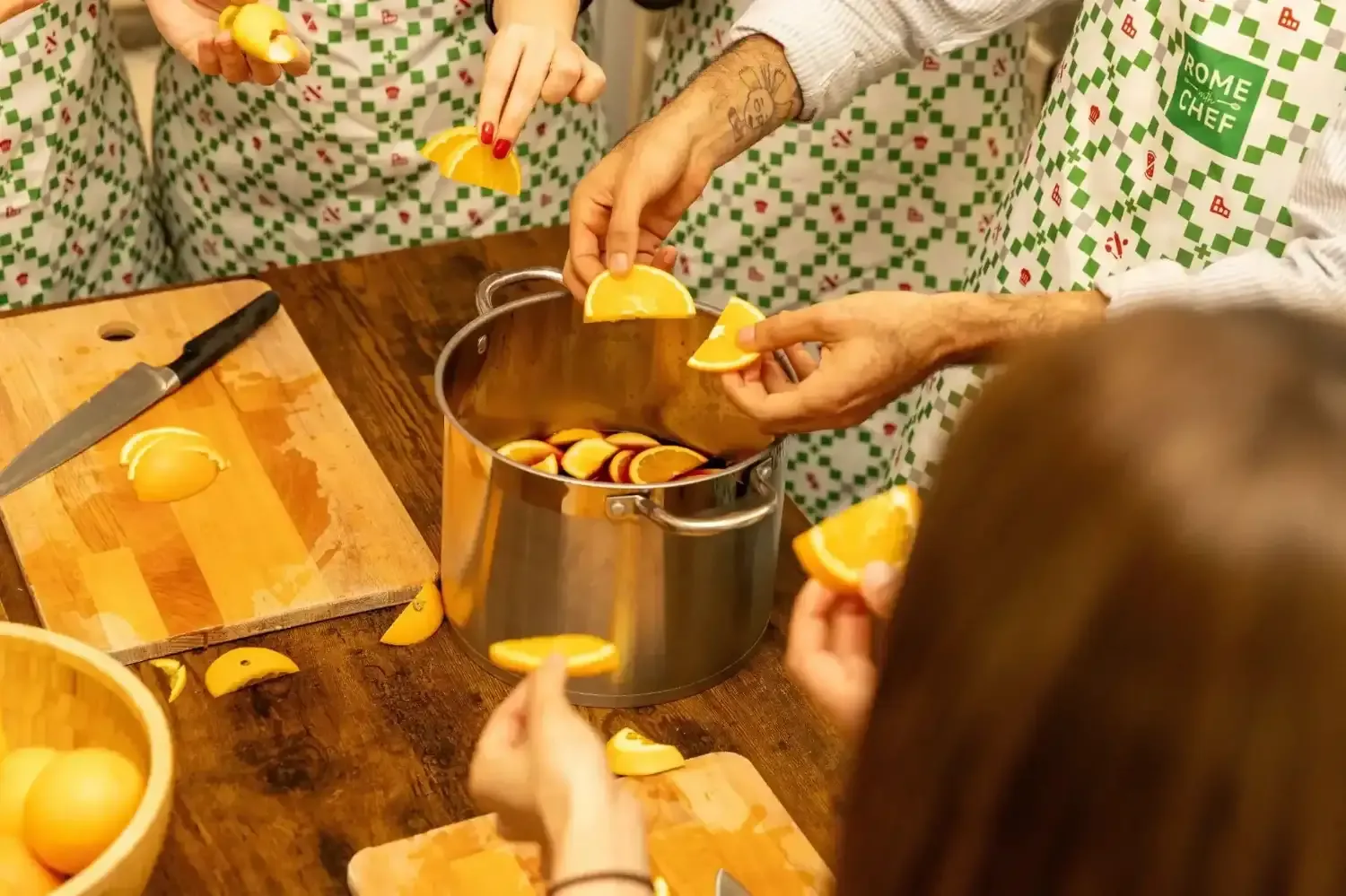 Students adding oranges to pot