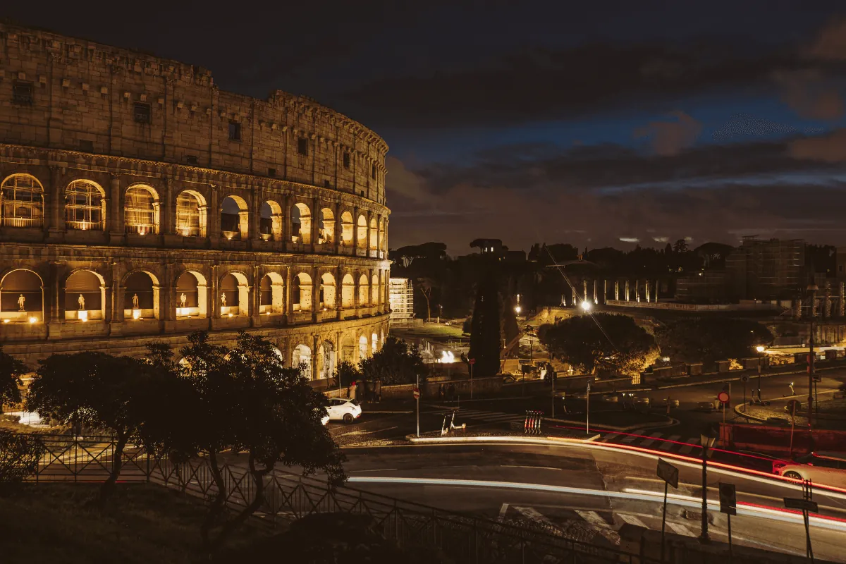 The Colosseum in Rome illuminated at night, representing things to do in Rome at night