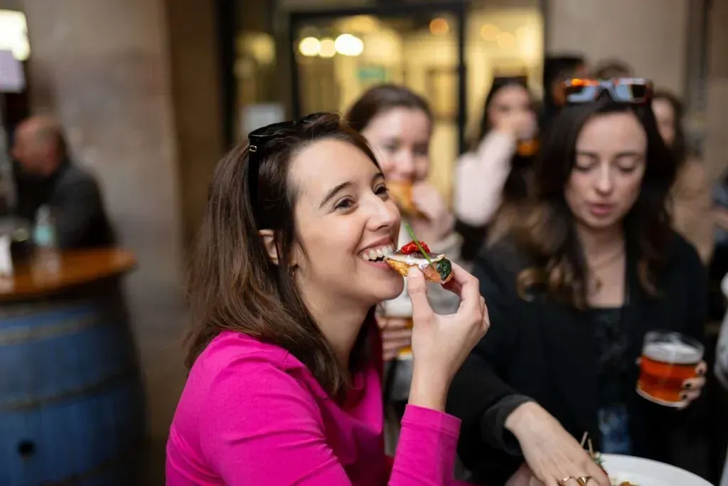 Happy tourists enjoying delicious tapas and drinks during Tipsy Tapa Tour showcasing Spanish culinary culture and social dining experience featured in Carpe Diem Tours food tour and cultural exploration adventure