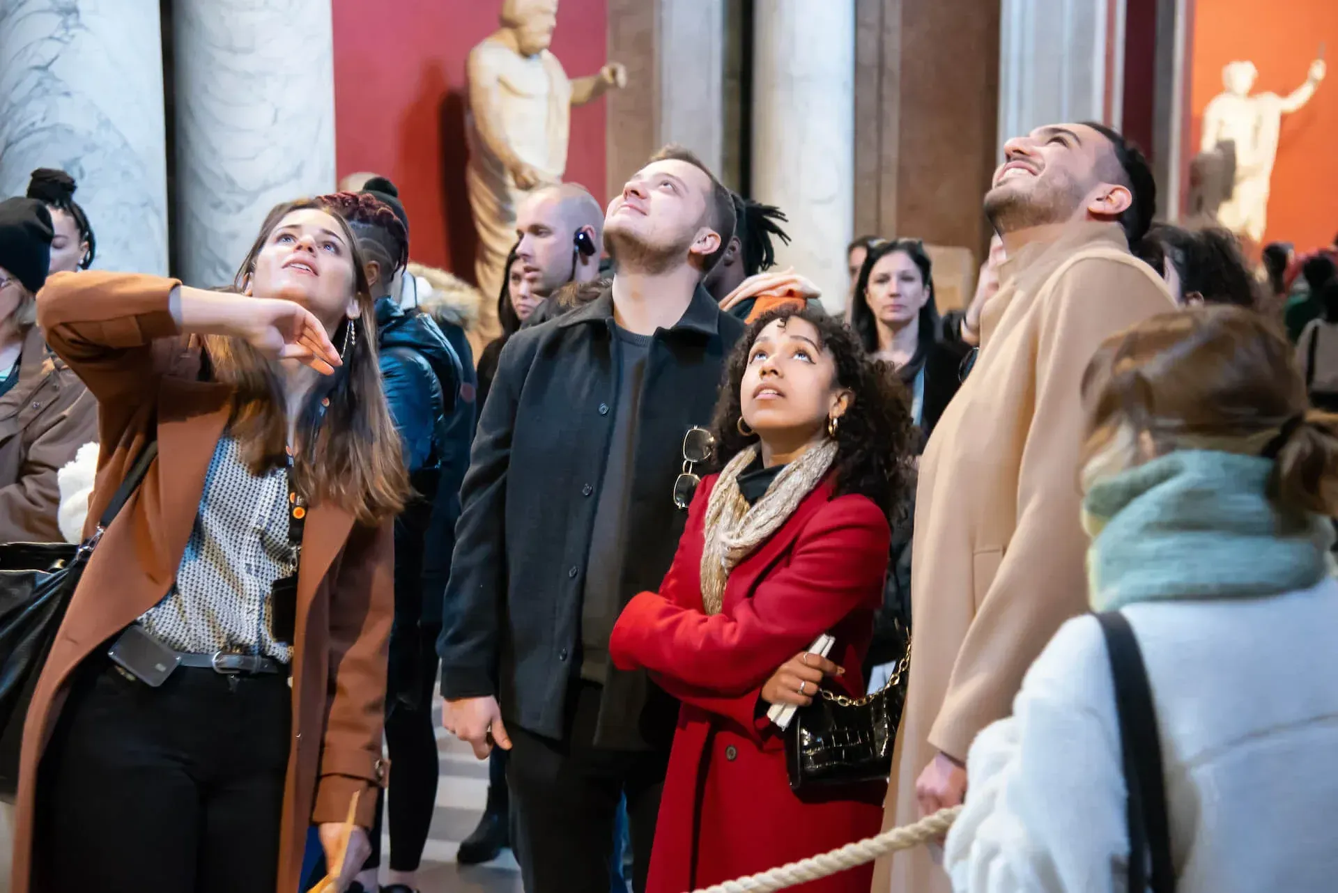 Professional Vatican tour guide demonstrating expertise to small group of travelers