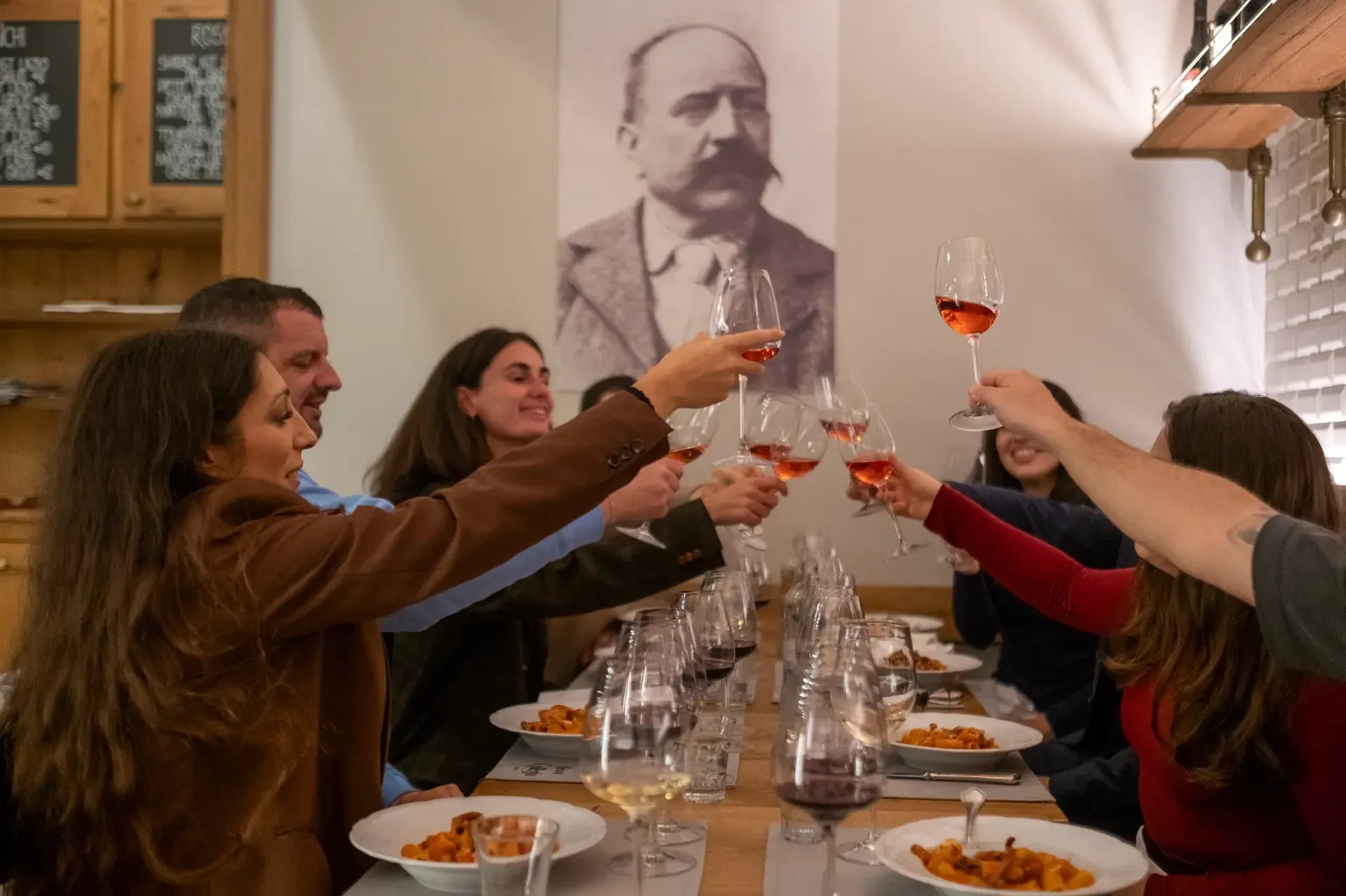 A sommelier pouring wine for a couple during an intimate fine dining experience.